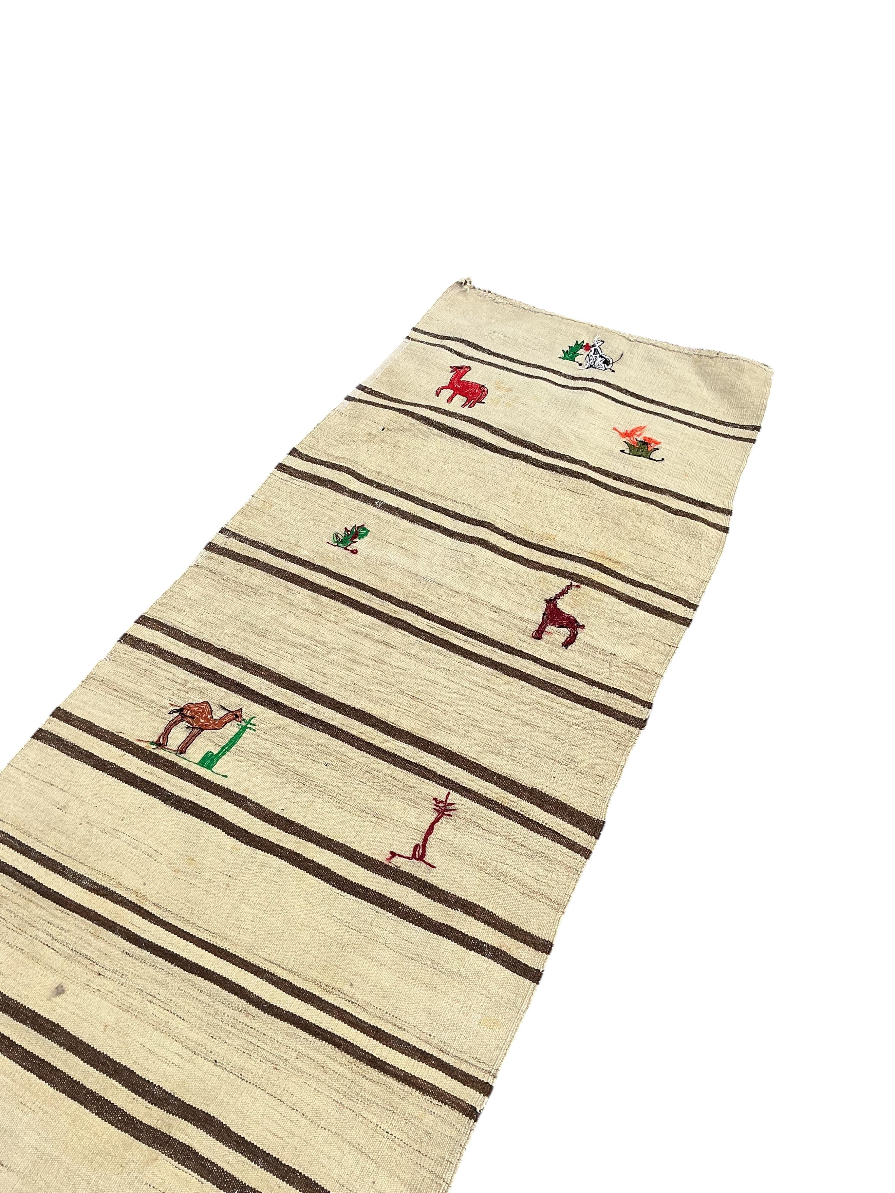 A Turkish kilim flat weave runner woven with animals and flowers, 370 x 82cm